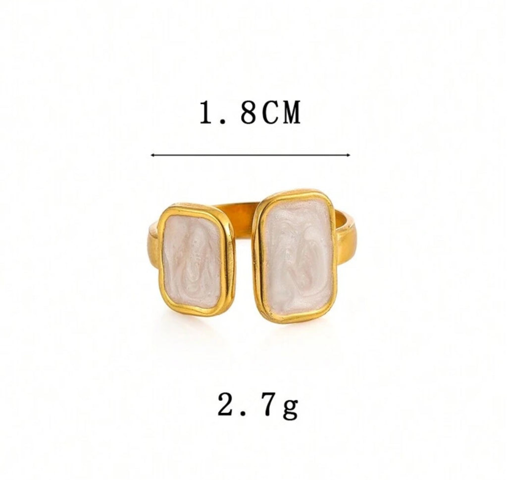 Close-up view of the Cloudstone Adjustable Ring featuring a smooth marble-inspired pearl centerpiece with a gold adjustable band