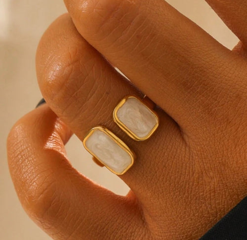 Flat lay of the Cloudstone Adjustable Ring showcasing its glossy pearl-like stone and open-ended adjustable band