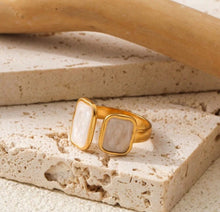 Load image into Gallery viewer, Flat lay of the Cloudstone Adjustable Ring showcasing its glossy pearl-like stone and open-ended adjustable band