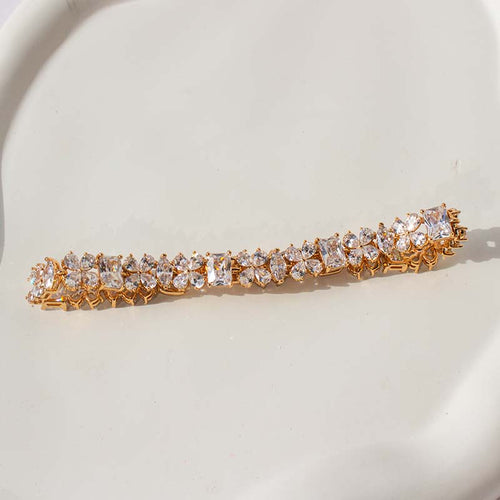 Elegant gold bracelet with diamond-studded crystal stones