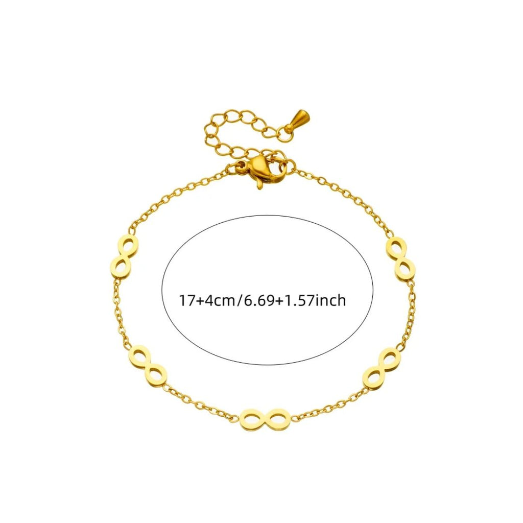 Gold bracelet with infinity symbol on a white background