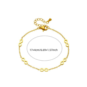 Gold bracelet with infinity symbol on a white background