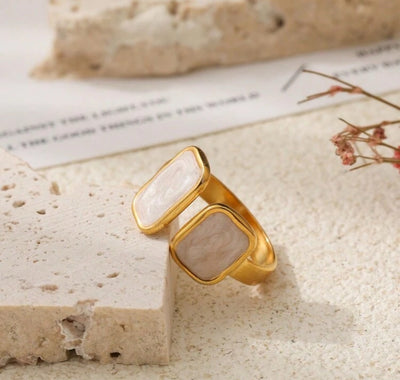 Side view of the Cloudstone Adjustable Ring highlighting the 18K PVD gold plating and polished marble effect pearl