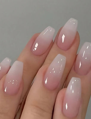 Hand with pink and white gradient nail polish on a gray background