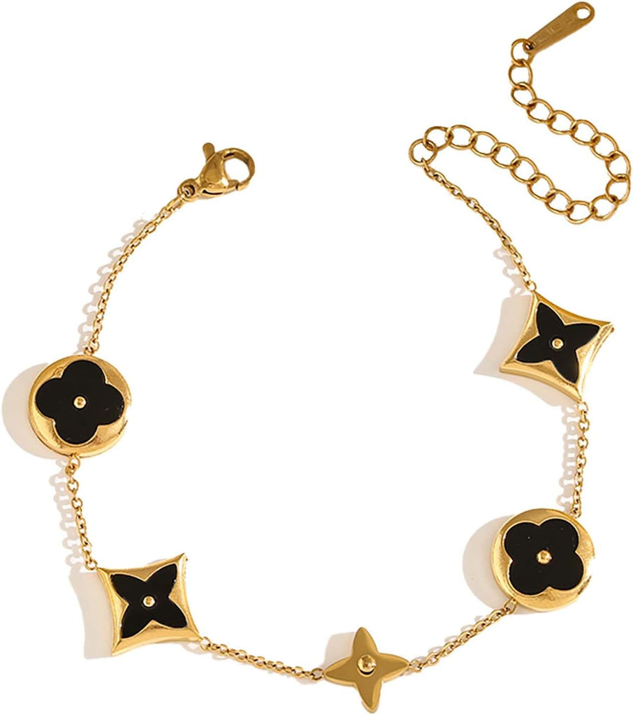 Gold and black bracelet with floral design on a white background