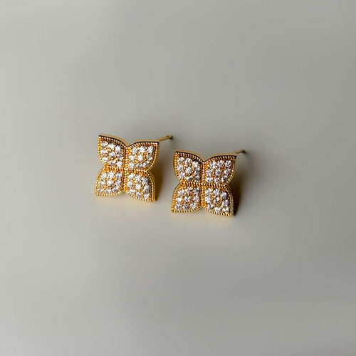 Golden clover-shaped stud earrings with zircon stones