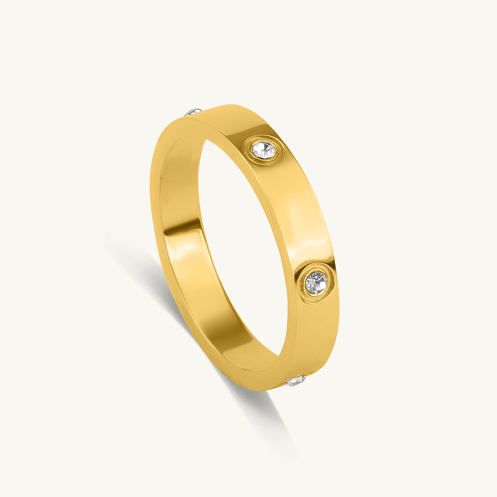 Gold ring with embedded diamonds on a white background