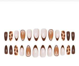 Set of nail art designs with brown, white, and tortoiseshell patterns on a white background