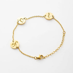 Gold bracelet with circular charms on a white background