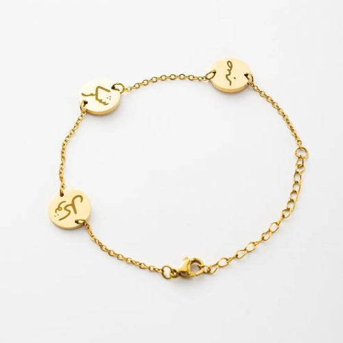 Gold bracelet with circular charms on a white background