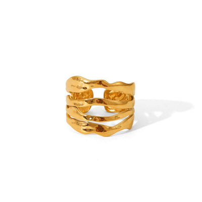 Gold ring with wavy design on a white background